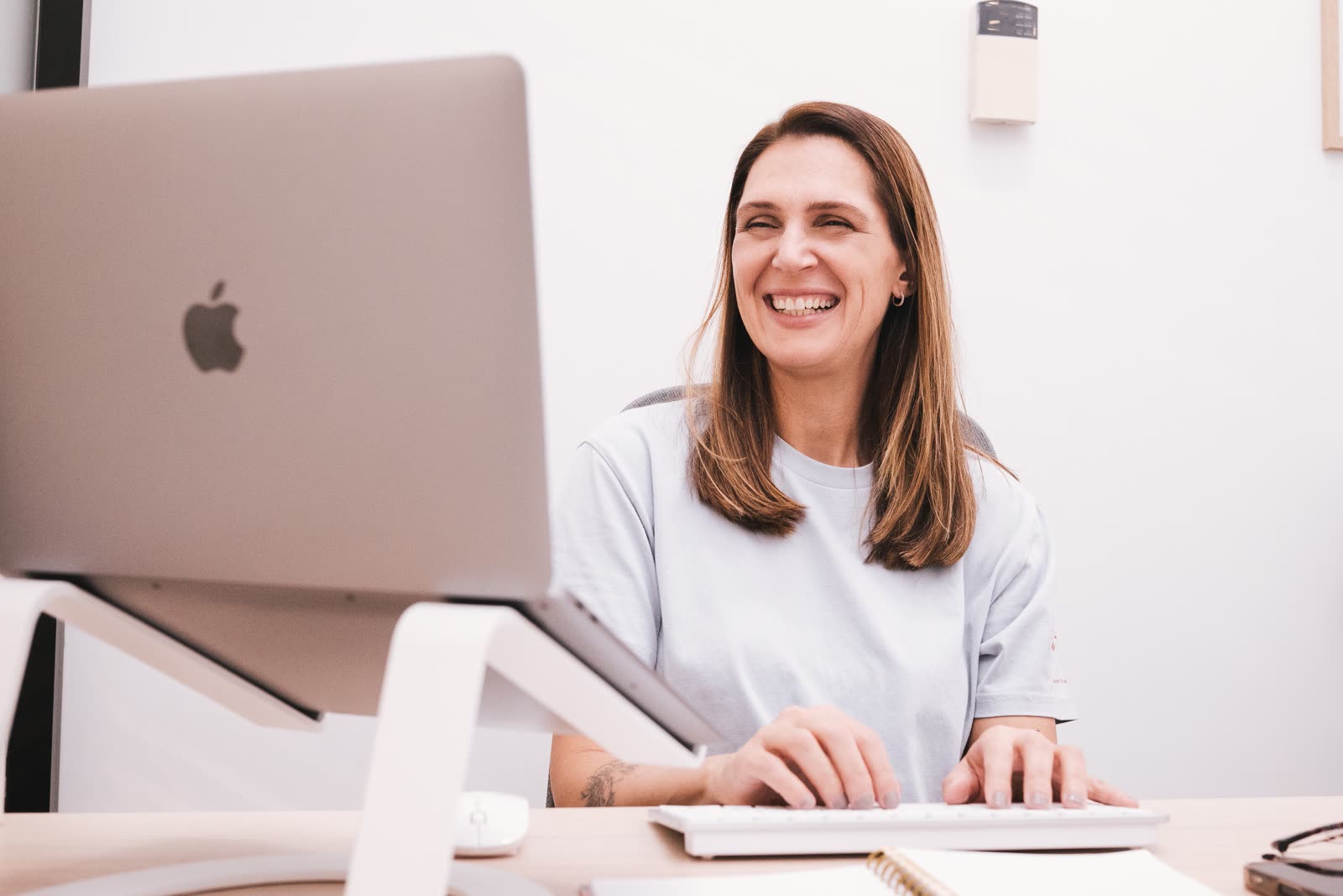 Amanda working at her desk, laughing